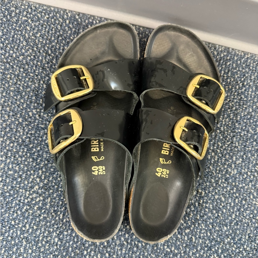 Birkenstock Glossy Black Sandals with Gold Accents